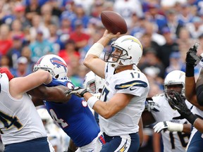 San Diego Chargers quarterback Philip Rivers throws a pass under pressure by Buffalo Bills defensive end Mario Williams during the first half at Ralph Wilson Stadium on September 21, 2014. (Kevin Hoffman/USA TODAY Sports)