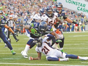 Seattle’s Marshawn Lynch dives in for the game-winning touchdown on Sunday against Denver. (USA TODAY SPORTS)