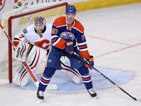 The Edmonton Oilers' Benoit Pouliot (67) tries to screen the Calgary Flames' Joni Ortio (37) during first period pre-season NHL action at Rexall Place in Edmonton Alta., on Sunday Sept. 21, 2014. David Bloom/Edmonton Sun/QMI Agency
