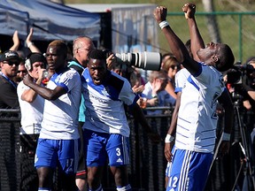 (left to right) FC Edmonton's Lance Laing (17), Eddie Edward (3) and Kareem Moses (12) celebrate Laing's goal against the Tampa Bay Rowdies' during second half NASL action at Clarke Stadium in Edmonton Alta., on Sunday Sept. 21, 2014. David Bloom/Edmonton Sun/QMI Agency