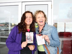Ben Leeson/The Sudbury Star/QMI Agency

Ornella Coulombe, left, and Pamela Sauerbrei hold up their Cinefest passes as they prepare to head inside Silver City on Saturday.