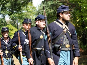 Re-enactors dressed as Union soldiers in the 42nd New York infantry walk toward their impending doom at the annual American Civil War re-enactment in Otterville on Sunday.  BRUCE CHESSELL/Sentinel-Review