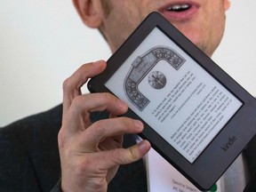 A journalist shows the new Kindle Voyage during a launch event in New York Sept. 17, 2014. REUTERS/Brendan McDermid