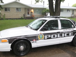 A Winnipeg Police cruiser sits outside a house in Winnipeg, Man. in this file photo taken Sunday June 23, 2013.
(BRIAN DONOGH/QMI AGENCY)