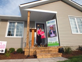 Sharon Silk and Karen Ramsey on the porch of their new home in Petrolia, built by Habitat for Humanity in conjunction with Lambton County Developmental Services. (BRENT BOLES/ QMI Agency)