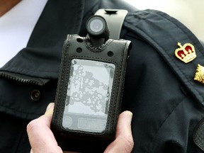 An Edmonton Police office wears a body-mounted video camera. (QMI Agency files)