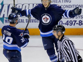 Winnipeg Jets #38 Nic Petan celebrates his overtime winner with teammate Ryan Olsen against the Vancouver Canucks during the 2014 Young Stars Classic Tournament in Penticton last week. Petan is excited to play a game at MTS Centre. (Al Charest/QMI Agency file photo)