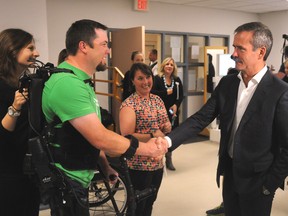 International Space Station Commander Chris Hadfield speaks to spinal cord injury patients Lee Thibeault and Mike Munro Thursday, September 18 at Parkwood Hospital. Hadfield was checking out exoskeleton rehabilitation equipment designed to help people walk again. GERARD CRECES/SPECIAL TO QMI AGENCY