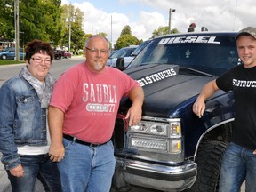 Jody and Rob Brown (left), of Dublin, pose with James Hope, of Orangeville and 519Trucks Facebook site prior to a memorial ride Sunday, Sept. 21 for the Brown’s late son Travis. More than 280 trucks congregated in Mitchell and drove to Dublin for a fundraising barbeque for the Dublin ball park. ANDY BADER/MITCHELL ADVOCATE