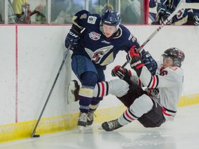 Spruce Grove Saints defence Connor James, pushes Whitecourt Wolverines defence Gordie Ballhorn, during a game on Friday, Sept. 19, 2014 at the Allan & Jean Millar Centre in Whitecourt. The Saints defeated the Wolverines 4 - 0.