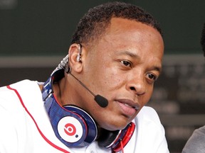 Recording artist Dr. Dre wears a pair of Beats headphones as he attends MLB's 2010 season opener to watch the reigning World Series Champions New York Yankees take on the Boston Red Sox at Fenway Park in Boston, Massachusetts in this file photo taken April 4, 2010. REUTERS/Adam Hunger/Files