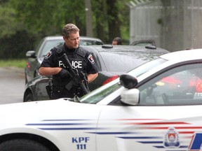 A Kingston Police officer holds a rifle during an incident at CFB Kingston. (Ian MacAlpine/Whig-Standard file photo)