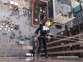 Paulette Leclair dressed as a nun in her first ever attempt at rappelling down a 19- story building as part of the Easter Seals Drop Zone Monday, Sept. 22, 2014. Brave individuals changed lives by harnessing up and rappelling 19 storeys down the Morguard building (280 Slater St.)
Errol McGihon/Ottawa Sun/QMI Agency
