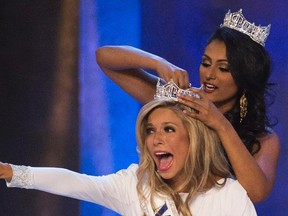 Miss New York Kira Kazantsev (front) reacts as she is crowned the winner of the 2015 Miss America Competition by Miss America 2014 Nina Davuluri in Atlantic City, New Jersey September 14, 2014.  REUTERS/Adrees Latif