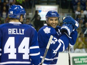 Toronto Maple Leafs forward Nazem Kadri smiles as he talks with teammate Morgan Rielly during a media timeout during NHL preseason hockey action against the Philadelphia Flyers at Budweiser Gardens in London, Ont. on Monday September 22, 2014. 
Craig Glover/London Free Press/QMI Agency