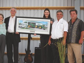 In celebration of 50 years in business the Podolinsky family was presented with a portrait on behalf of the John Deere Co. From left is Anne Podolinsky, John Deere division sales manager Peter Zuccolo, territorial manager Jenifer Christie, Louie Podolinsky and Rick Podolinsky