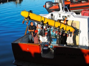 Researchers aboard the Parks Canada vessel Gwaii Haanas II use University of Victoria's Autonomous Underwater Vehicle Bluefin-12S to search deep underwater off the B.C. coast for evidence of ancient civilizations. (Handout)