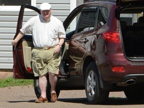 Senator Mike Duffy exits his vehicle outside a pet kennel in Kensington, Prince Edward Island earlier this year. Once a close political ally of Prime Minister Stephen Harper, 31 criminal charges have been laid against Duffy, in the latest development in a long-running scandal. (REUTERS/Andrew Collins)
