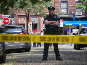 New York City police officer behind police tape. 

REUTERS/Darren Ornitz