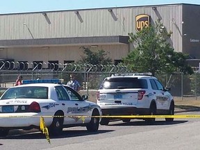 Police vehicles are seen outside a UPS service center following a deadly shooting in Birmingham, Alabama September 23, 2014.   REUTERS/Sherrel Wheeler Stewart