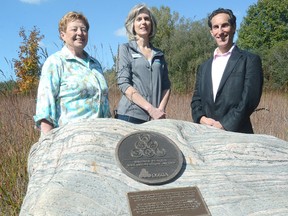 Zorra Township mayor Margaret Lupton, Jane McKelvie, chair of the Upper Thames River Conservation Authority, and Ted Wigdor, CEO of the Ontario Stone, Sand and Gravel Association, are shown with a bronze plaque recognizing Wildwood for its rehabilitation of its gravel pit. (SCOTT WISHART/The Beacon Herald)​