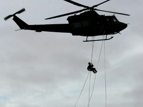 Reservists from various units in the 41 Canadian Brigade Group rappel from a CH-146 Griffon helicopter, from 408 Squadron, during a training exercise at Canadian Forces Base Edmonton on Saturday February 18, 2006. More than 200 reservists are taking part in Exercise Urban Grizzly throughout the weekend, which includes scenarios they might face in deployments overseas.