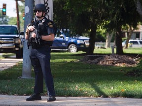A police officer guards the scene of a shooting at the Mercy-Fitzgerald Hospital in Darby, Pennsylvania on July 24, 2014. A gunman opened fire inside a Pennsylvania psychiatric facility on Thursday, killing a woman and wounding a doctor before he was shot and critically wounded, authorities said. REUTERS/Charles Mostoller