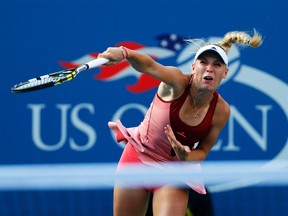 Caroline Wozniacki serves to Serena Williams during the U.S. Open women's singles final in New York, Sept. 7, 2014. (ADAM HUNGER/Reuters)