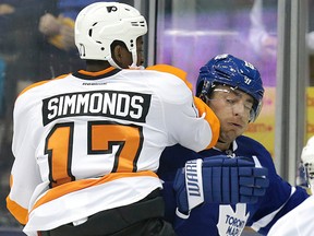 Maple Leafs forward Joffrey Lupul takes an elbow from Flyers winger Wayne Simmonds on Tuesday night at the Air Canada Centre. (Craig Robertson/Toronto Sun)