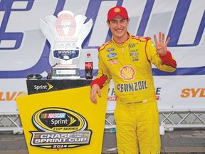 Joey Logano celebrates after winning the NASCAR Sprint Cup Sylvania 300 in New Hampshire on Sunday. (AFP)