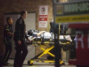 Paramedics transport a man who was shot outside a Vaughan home to hospital late Tuesday. (MANNY RODRIGUES/Special to the Toronto Sun)