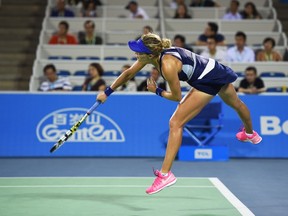 Eugenie Bouchard of Canada serves during her match against Alison Riske of the US at the Wuhan Open tennis tournament in Wuhan, in China's Hubei province on September 24, 2014.  (AFP PHOTO/Greg BAKER)