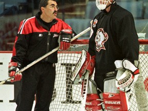Jim Corsi, a long-time NHL goalie coach seen here in 1999 with ex-Buffalo Sabres netminder Dominik Hasek, has an advanced stat named after him. (Reuters)