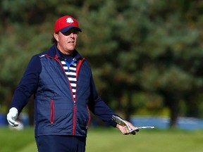 U.S. Ryder Cup player Phil Mickelson holds his yardage book as he stands on the 13th fairway during practice ahead of the 2014 Ryder Cup at Gleneagles in Scotland on September 24, 2014. (REUTERS/Russell Cheyne)