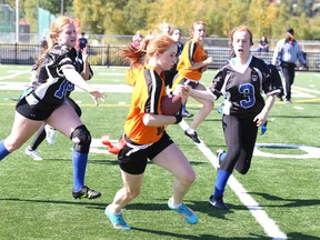 Brittany Lebel of the Lasalle Lancers makes a run with the ball while being chased down by Chelmsford Flyers Samuelle Labelle and Emily White, during high school flag football action from James Jerome Field on Wednesday afternoon.