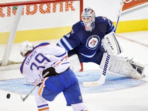 Oilers forward Bogdan Yakimov scores on Jets goalie Michael Hutchinson during the second period. (BRUCE FEDYCK/USA Today Sports)