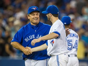 Blue Jays manager John Gibbons shares a handshake with pitcher Drew Hutchison after an August win. "Hutch and (Marcus) Stroman have proved what they really are," Gibbons said Sept. 24, 2014. (ERNEST DOROSZUK/Toronto Sun files)