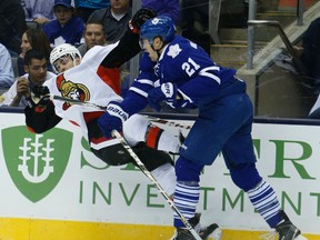 Maple Leafs winger James van Riemsdyk puts a big hit on the Senators’ Shane Prince last night at the Air Canada Centre. (Craig Robertson/Toronto Sun)