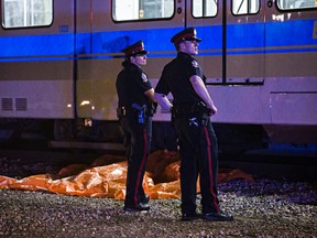 Officers investigate the scene after a fatal LRT mishap at Stadium station Wednesday night. (Codie McLachlan/Edmonton Sun)