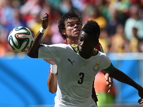 Ghana's forward and captain Asamoah Gyan (front) and Portugal's defender Pepe vie during the Group G football match between Portugal and Ghana at the Mane Garrincha National Stadium in Brasilia during the 2014 FIFA World Cup on June 26, 2014. (AFP PHOTO / FRANCISCO LEONG)