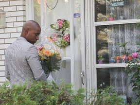 Ward 2 Candidate Andray Domise brings flowers to Mayor Rob Ford's house on Thursday September 25, 2014. (Stan Behal/Toronto Sun)