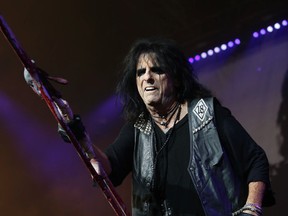Legendary master of the metal macabre Alice Cooper - playing "I'm 18" - was the opening act on a double with Mötley Crüe's on their Final Tour at the Molson Amphitheatre in Toronto, Ont. on Monday August 11, 2014 . Jack Boland/Toronto Sun