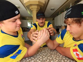 (left to right) Dalin Torresan, Dean Torresan, and Logan Torresan pose for a photo at their family home east of Edmonton, Friday July 6, 2012. The three were preparing to attend the Armwrestling World Championship in Brazil. Logan, 14, and Dalin, 17, were killed July, 2013, when their car was hit by a pickup truck one kilometre north of their house on Highway 16 and Range Road 213 east of Edmonton. (DAVID BLOOM EDMONTON SUN FILE)