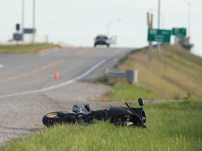 A motorcycle lies on the side of Kerwood Rd. after its rider lost control while crossing the Hwy. 402 overpass shortly before 2 p.m. on Thursday. CRAIG GLOVER/The London Free Press/QMI Agency