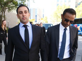 Drs. Amitabh Chauhan (L) and Suganthan Kayilasanathan walk away from court September 25, 2014 after they were cleared of of all charges related to allegations that they drugged and sexually assaulted a 23-year-old medical student in 2011. (Jack Boland/Toronto Sun)