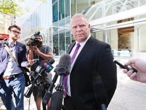 Mayoral candidate Doug Ford speaks to the media in downtown Toronto on Thursday September 25, 2014. (Stan Behal/Toronto Sun)