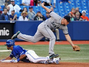 Seattle Mariners third baseman Kyle Seager reaches for an errant throw as Toronto Blue Jays outfielder Dalton Pompey slides safely into third with a stolen base at the Rogers Centre, Sept. 25, 2014. (DAN HAMILTON/USA Today)