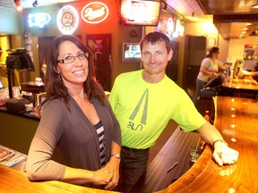 Lou-Ann (l) and Joe Andrews stand in the Pandora Inn in Winnipeg, Man. Thursday September 25, 2014. The couple has recently re-opened the Inn after a major water main break in January.