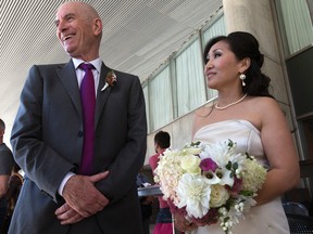 Kevin Mcloughlin and Kim Park were supposed to be married at City Hall but due to the fire and power outage they were married at Osgoode Hall on Thursday, September 25, 2014. (Dave Abel/Toronto Sun)