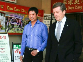 David Chen (L), owner of Lucky Moose Food Mart, endorses mayoral candidate John Tory on Thursday, Sept. 25, 2014, in Chinatown. (Veronica Henri/Toronto Sun)